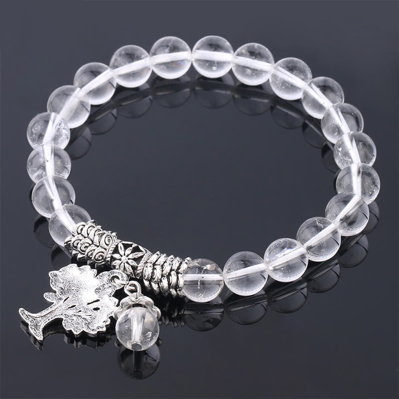 Tree of Life clear quartz bracelet with transparent rock crystal beads, silver-toned tree-of-life pendant and oak leaf acorn charm.