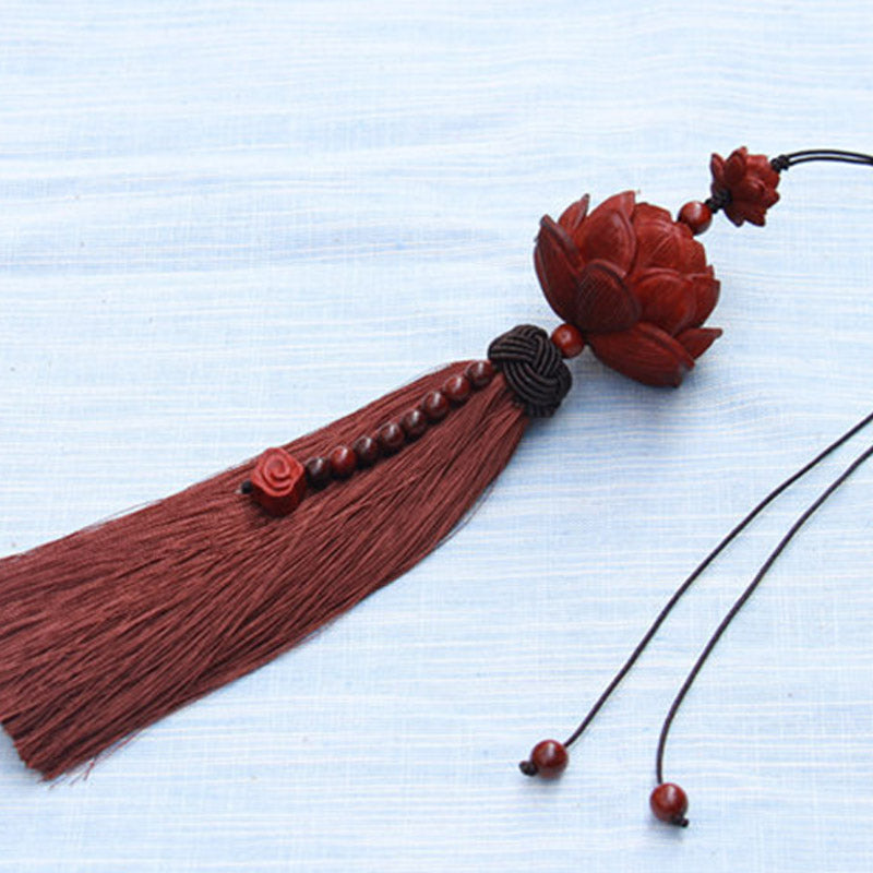 Red Sandalwood Lotus Tassel - full ornament on light fabric, carved lotus and long fringe