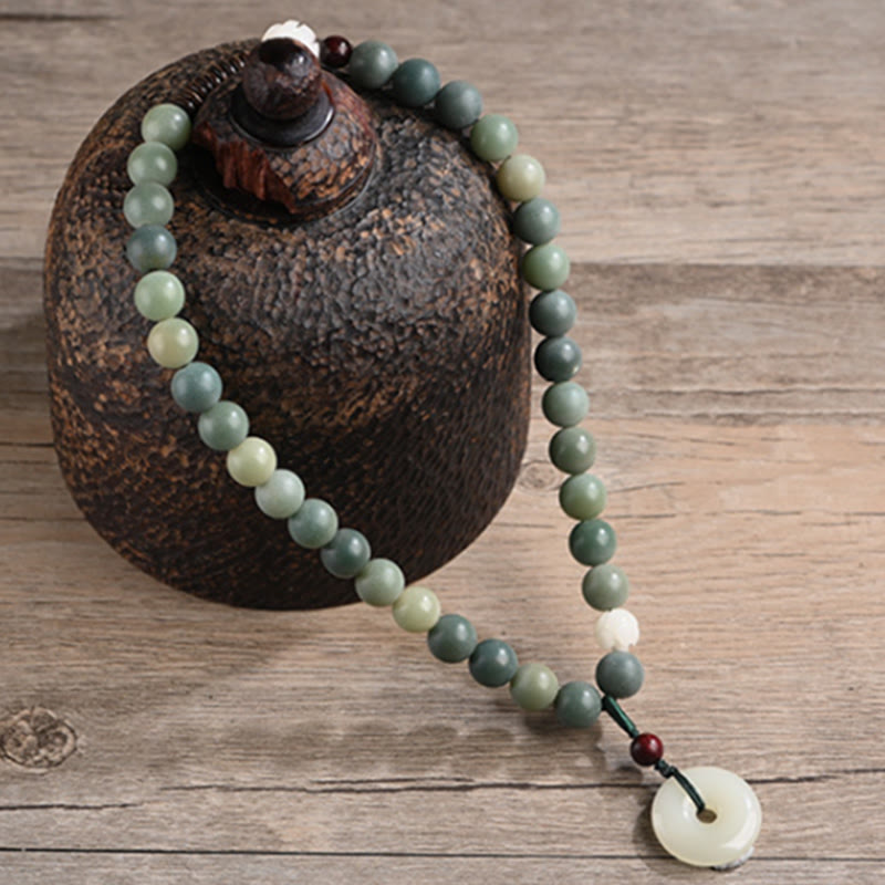 Cyan Bodhi Seed Jade Peace Buckle Bracelet - green bead mala over earthenware pot, peaceful zen setting