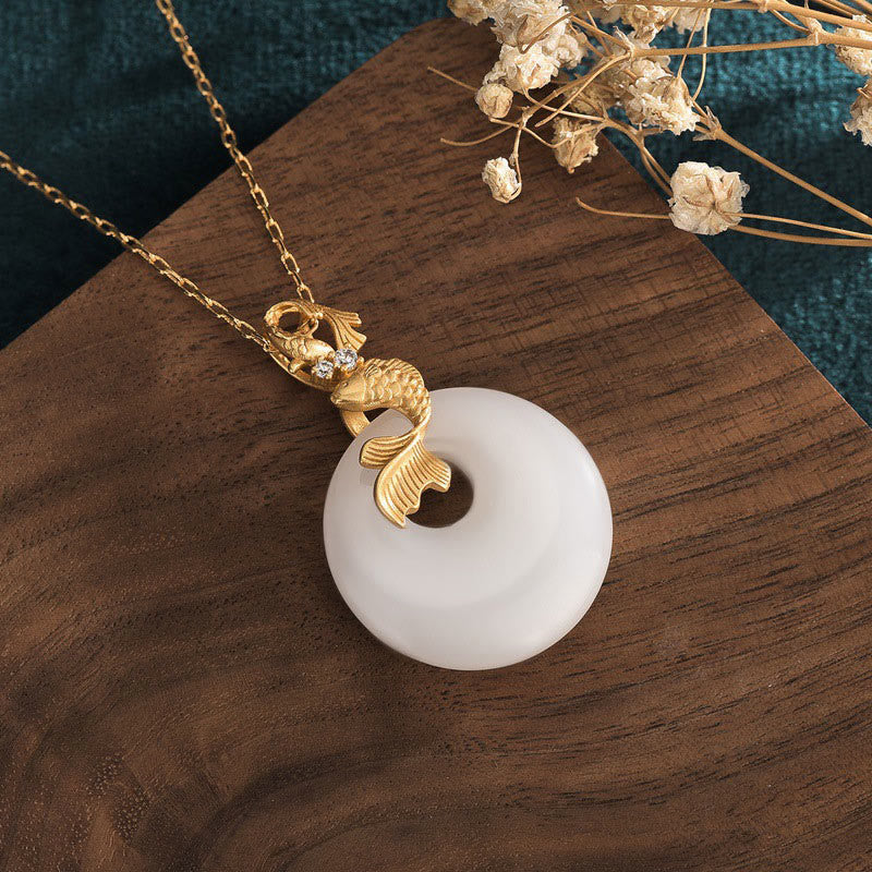 White Jade Koi Necklace – Close-up of carved white jade koi fish pendant, Chinese wealth amulet