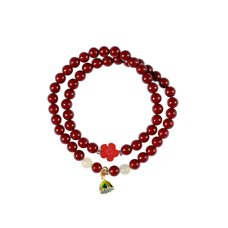 Cinnabar Lotus Bracelet – top-down view showing double strand and cloisonne pendant, red beads