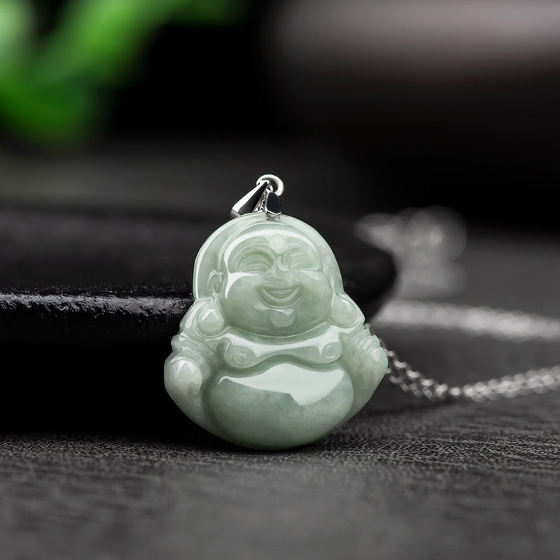 Jade Laughing Buddha Blessing Necklace – three-quarter view of pale green Maitreya on dark stone prop, studio