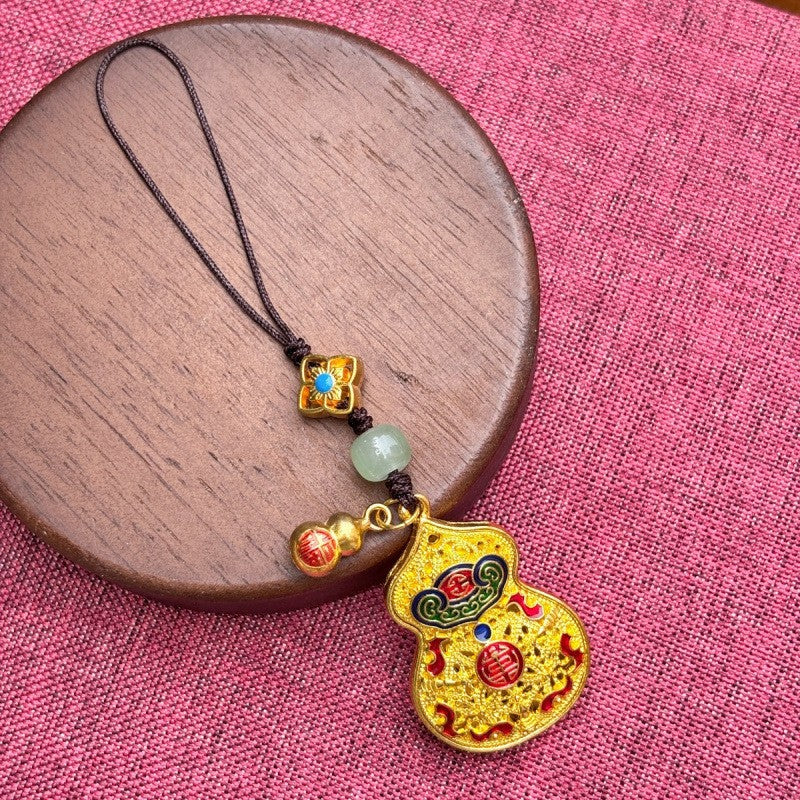 Gold enamel calabash keychain with jade bead and fortune charm, gold twisted cord