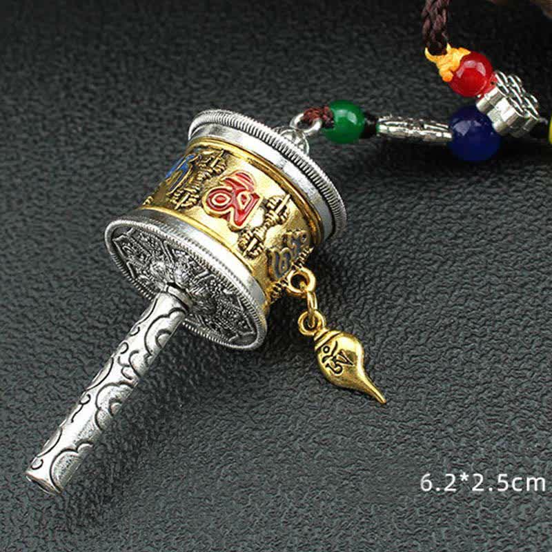 Tibetan Prayer Wheel Tassel – Gold silver prayer wheel with turquoise red beads on white background