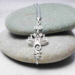 Lotus Luck Wealth Titanium Necklace – silver openwork lotus on stacked river pebbles, new beginnings