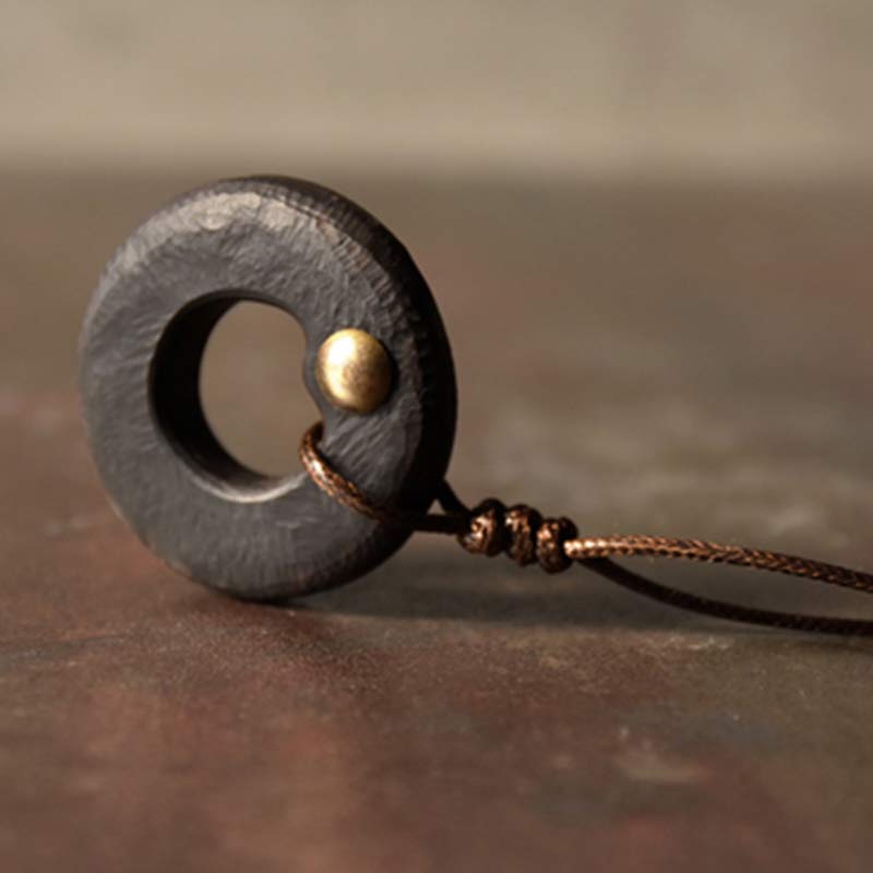 Ebony Wood Ring Pendant - dark circle with brass accent on brown braided cord, handcrafted artisan jewelry