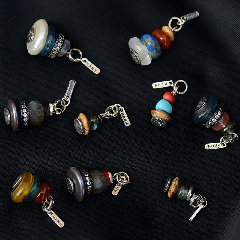 Zen Cairn Crystal Pendant – eight artisan pendants with oxidized silver spacers on dark fabric, bohemian jewelry