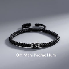 Om Mani Padme Hum Braided Peace Bracelet – flat lay with engraved silver charm, silver braid bracelet