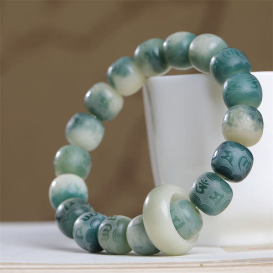 Bodhi Seed Om Mani Padme Hum Bracelet – Full loop on white stand showing carved mantra beads, bodhi seed jewelry