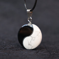 Black Obsidian White Turquoise Yin Yang Transformation Necklace Pendant - Close-up obsidian turquoise yin-yang with silver ba