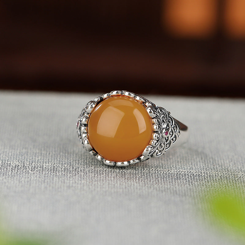 Vintage Silver Honey Amber Ring – Amber cabochon ring on gray linen with dark wood background, feng shui