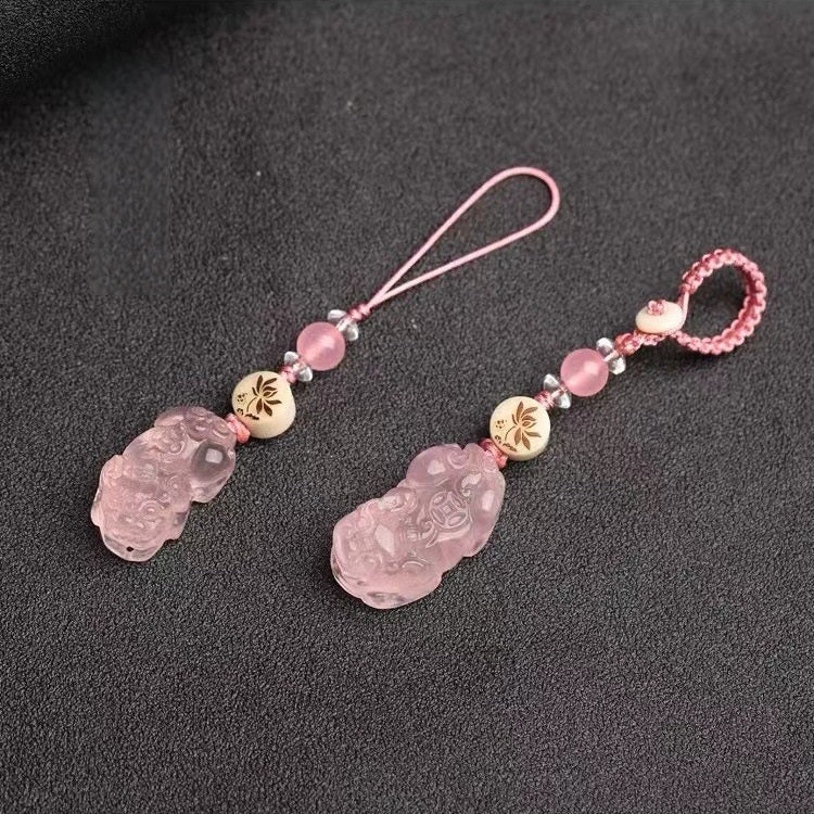 Quartz Fox Keychain – rose quartz pixiu pair with braided pink loop and clear crystal accents on charcoal surface, love charm