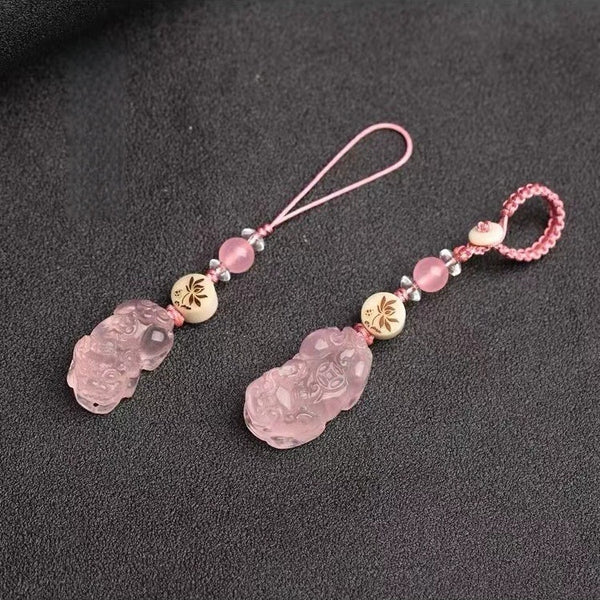 Quartz Fox Keychain – rose quartz pixiu pair with braided pink loop and clear crystal accents on charcoal surface, love charm