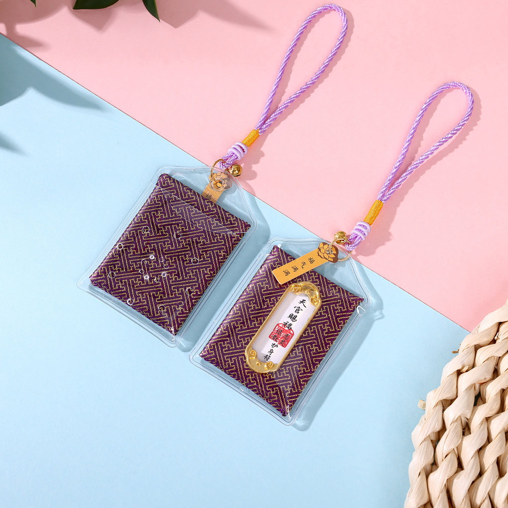 Two purple body protection amulets on pink and blue background