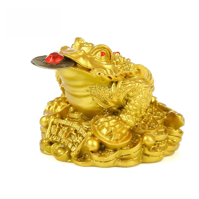 Golden Money Toad – side view of gold frog atop stacked coins and ingots white background, prosperity charm
