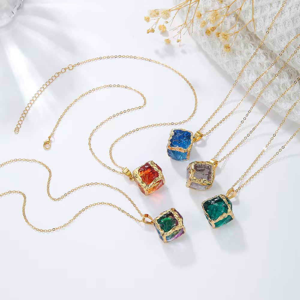 Gemstone Chip Pendant – Five colorful gemstone cube pendants flat lay on white with dried flowers, necklace set