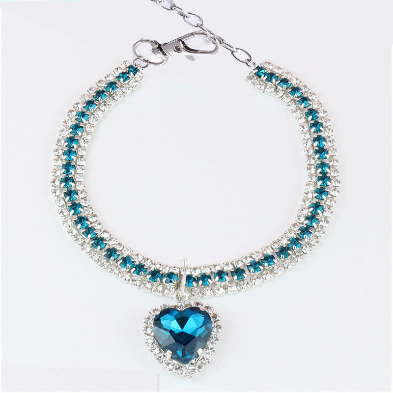 Heart Crystal Pet Collar – triple row teal blue crystals with blue heart pendant, halo setting, flat lay