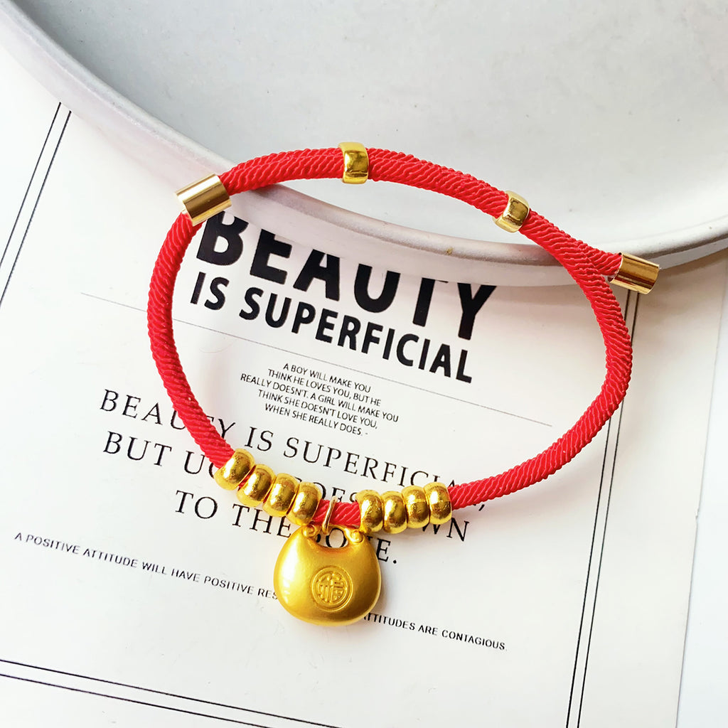 Longevity Lock Pet Collar - Red cord with gold Fu bag pendant on ceramic dish, adjustable gold lucky pet necklace