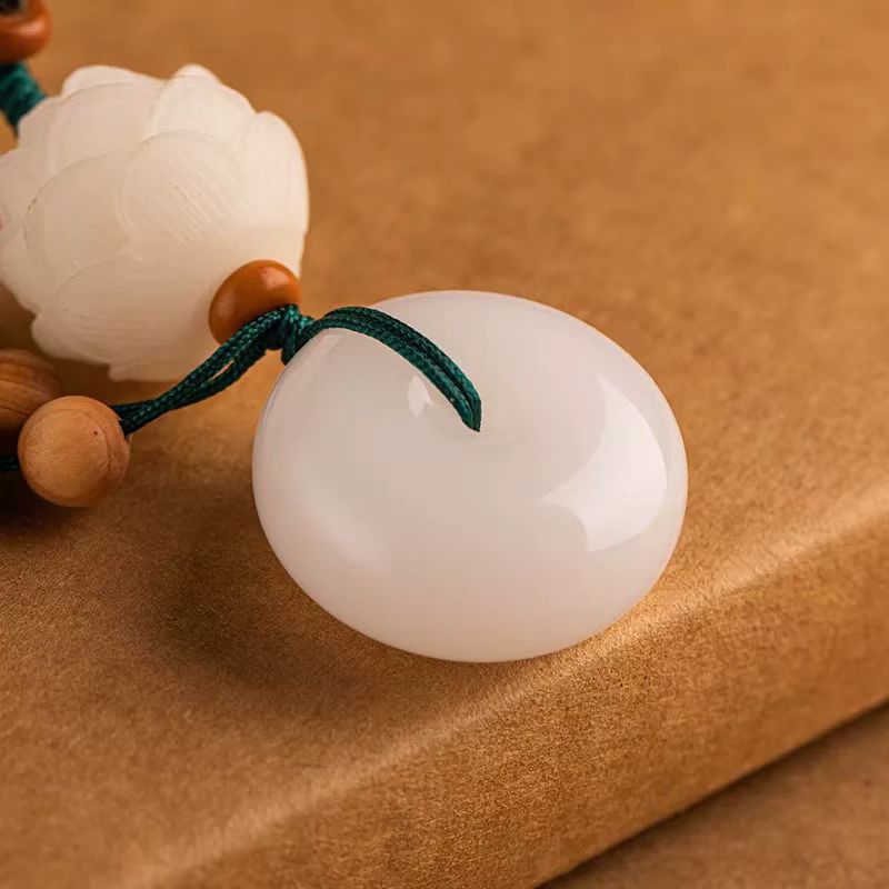 Chalcedony Lotus Keychain – close-up of smooth white peace buckle and carved lotus bead detail, crystal keychain