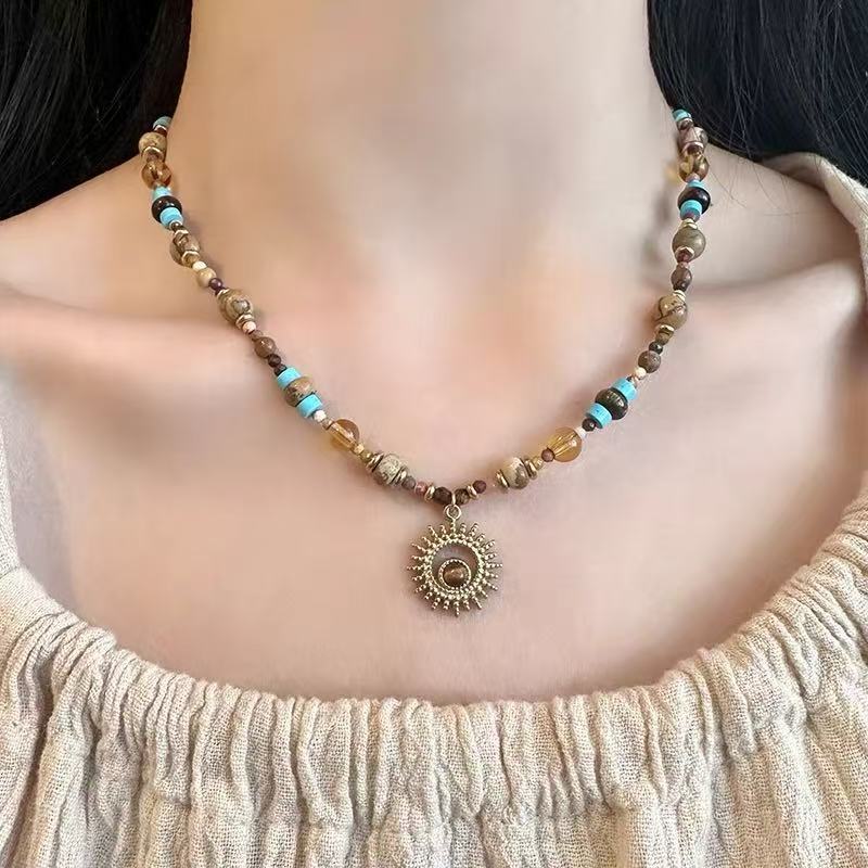 Sunflower Necklace – model wearing tiger eye beaded choker with sun pendant, cream knit top, confidence jewelry