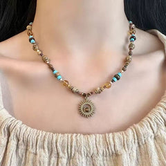 Sunflower Necklace – model wearing tiger eye beaded choker with sun pendant, cream knit top, confidence jewelry