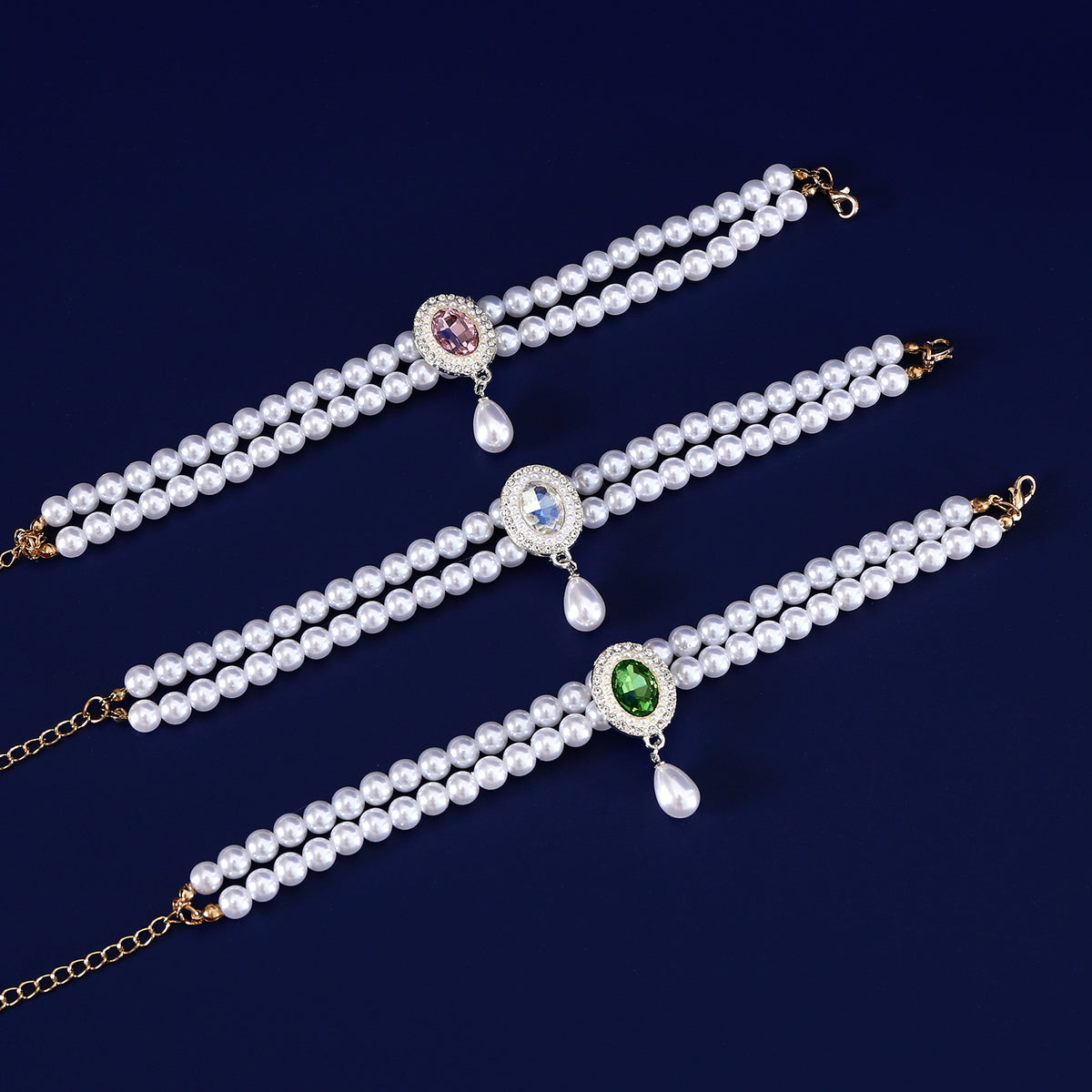 Luxury Pearl Pet Necklace – Three double-layer pearl collars with pink, blue and green crystal pendants, flat lay