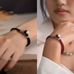 Persimmon Cord Bracelet – Split view of black and red cord bracelets on models, couple luck jewelry