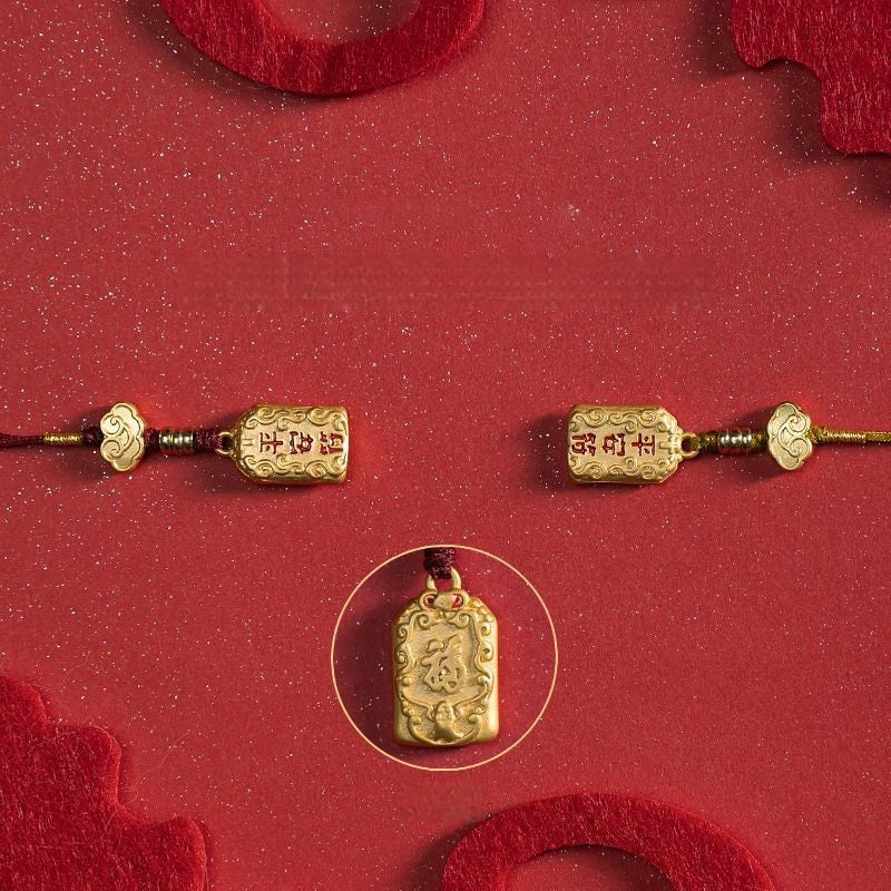 Three brass good luck charms flat lay showing front and back details on red background