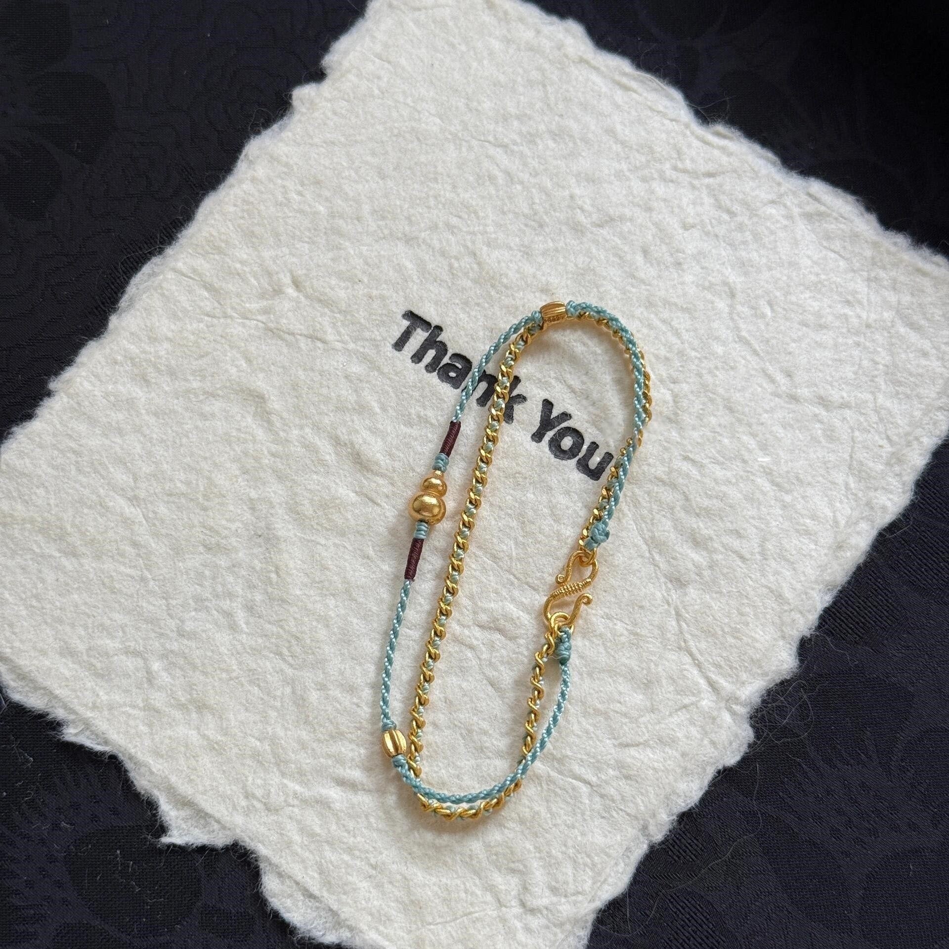 Double-Layer Gourd Bracelet – Detail of gold S-clasp and braided rope with gourd accent on white felt, handmade
