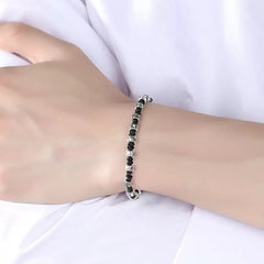 Zen Mantra Cord Bracelet – worn on wrist with white sleeve, silver mantra bead details visible on black rope, meditation wear