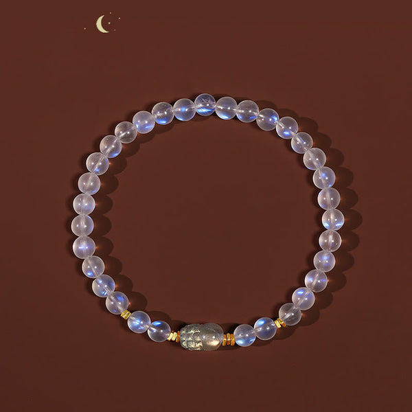 Moonstone PiXiu Bracelet – Full circle moonstone beads with PiXiu on brown background with moon, serenity
