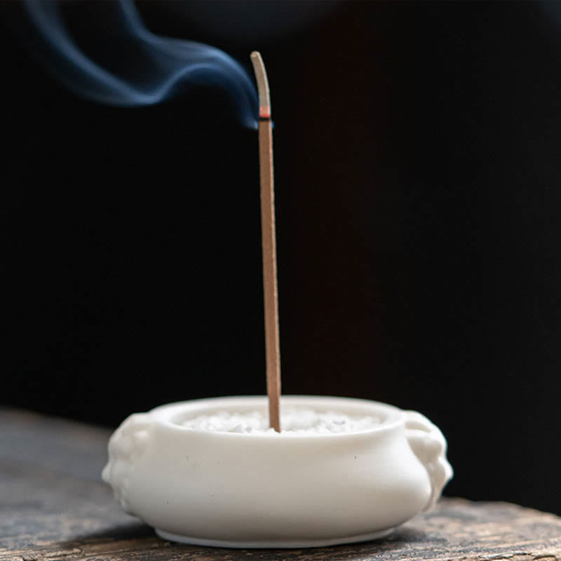 Dragon Ceramic Incense Burner – lion head censer with ash on dark tray, teapot accent, garden bokeh, auspicious