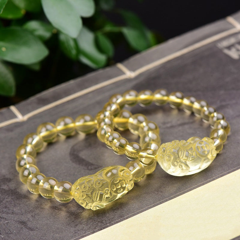 Citrine PiXiu Wealth Bracelet – pair of bracelets arranged overlapping on dark surface, yellow citrine wealth beads, good fortune
