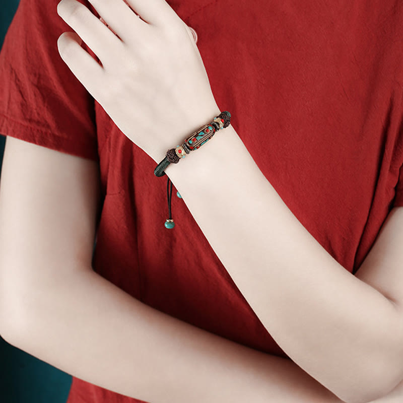 Tibetan Turquoise Om Mani Padme Hum Braided Bracelet – Worn on wrist with warm terracotta clothing, ethnic cord bracelet