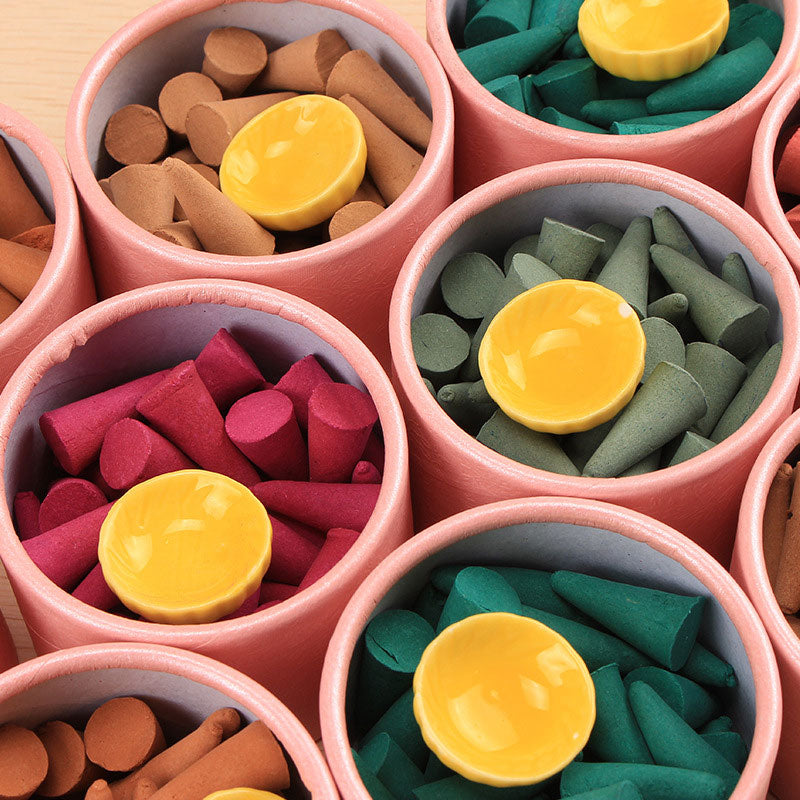 Tibetan incense cones – top view of colorful cones in pink cardboard tubes, soothing