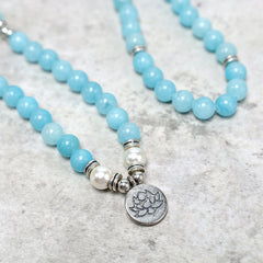 Amazonite Lotus Mala close-up of silver lotus pendant with blue beads and pearls, healing