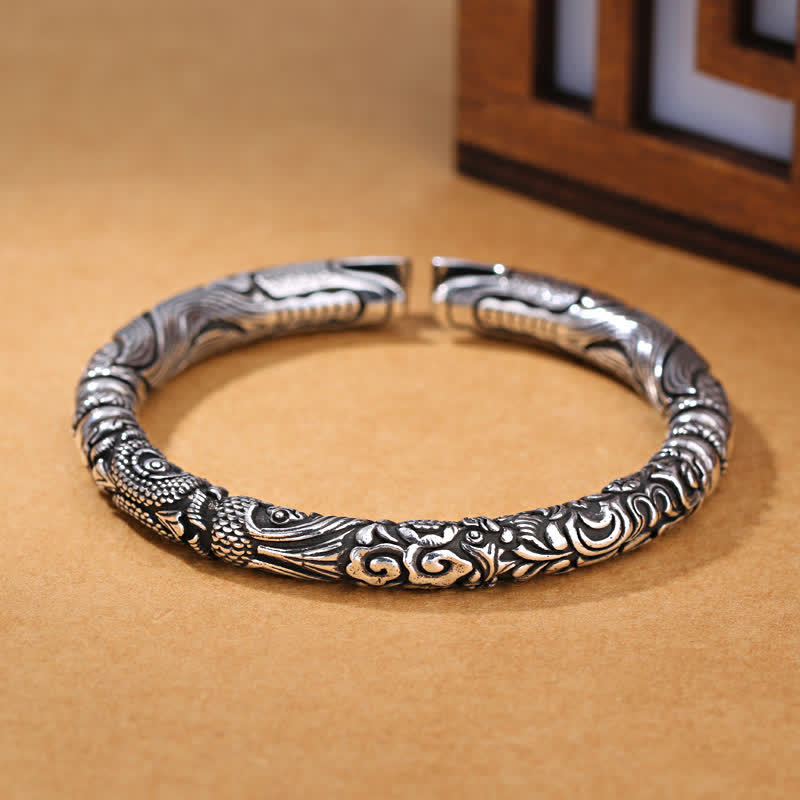 Dragon Head Carved Luck Bangle – low angle showing relief dragon fish clouds, Artisan Craft