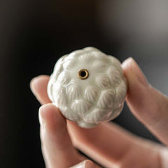 Ceramic Lotus Incense Burner held in hand showing compact palm-sized form, artisanal
