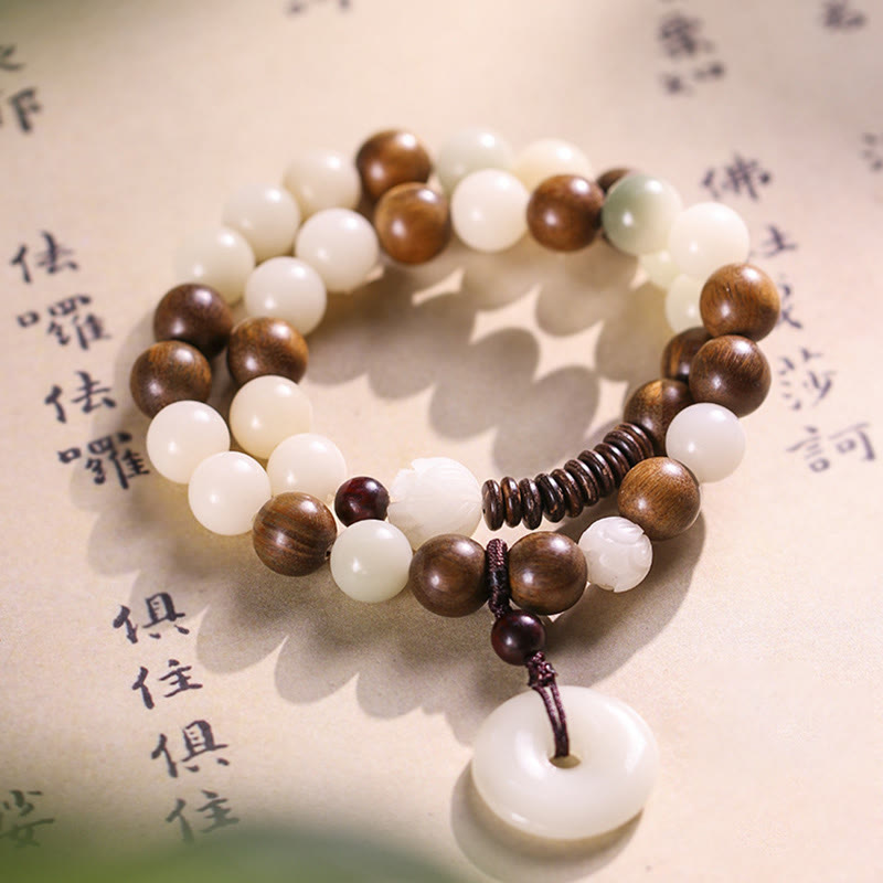 Bodhi Seed Sandalwood Lotus Bracelet - detail split of peace buckle pendant and carved lotus bead, artisan
