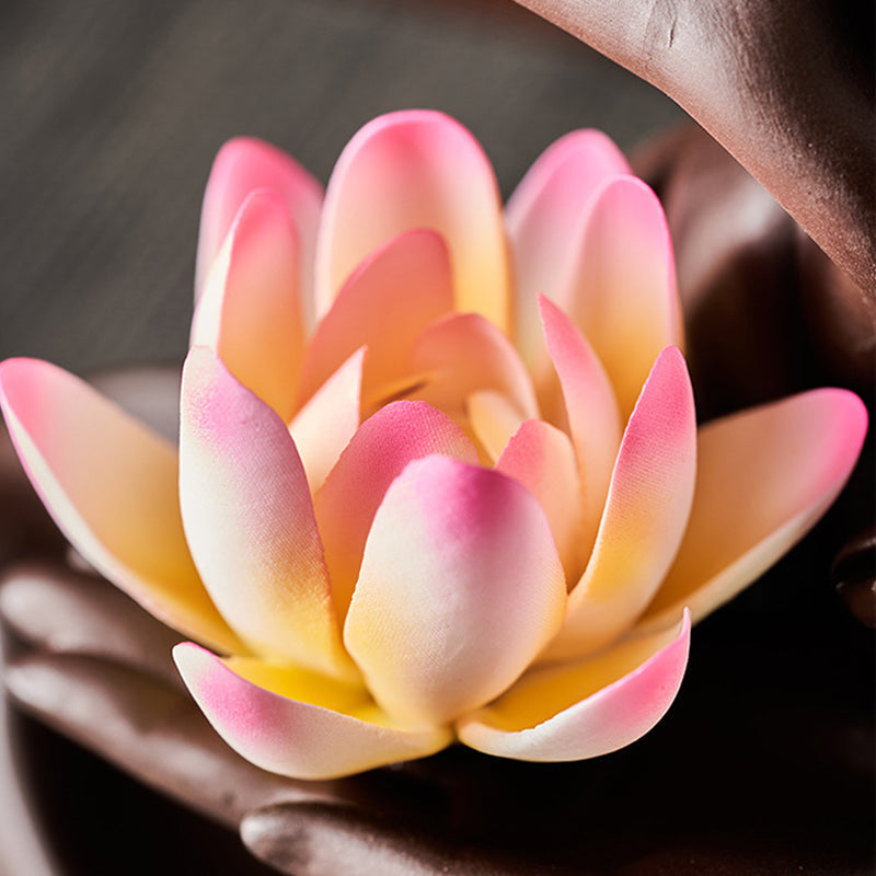 Lotus Bergamot Incense Burner – Dark clay hand sculpture with lotus on textured fabric, zen decor
