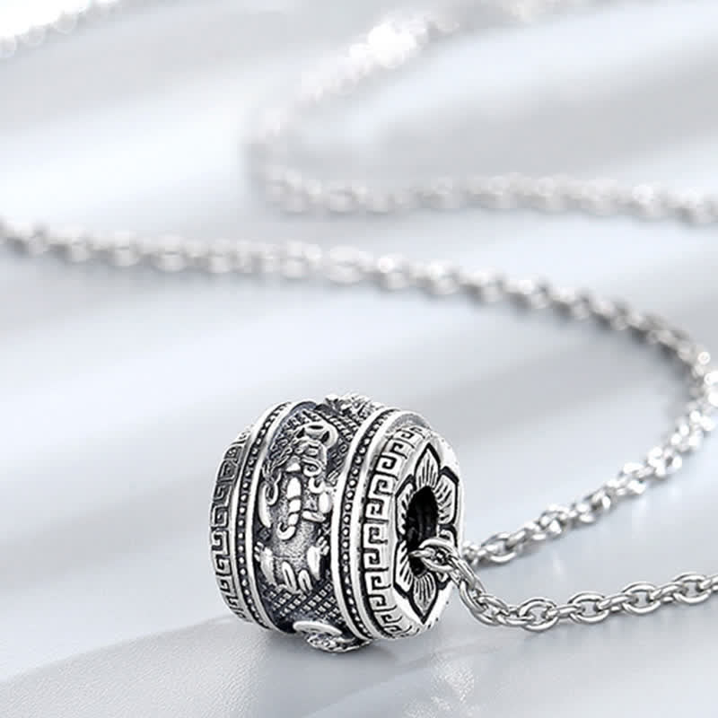 PiXiu Luck Wealth Rotatable Necklace Pendant – close-up of engraved PiXiu on white silk, prosperity necklace