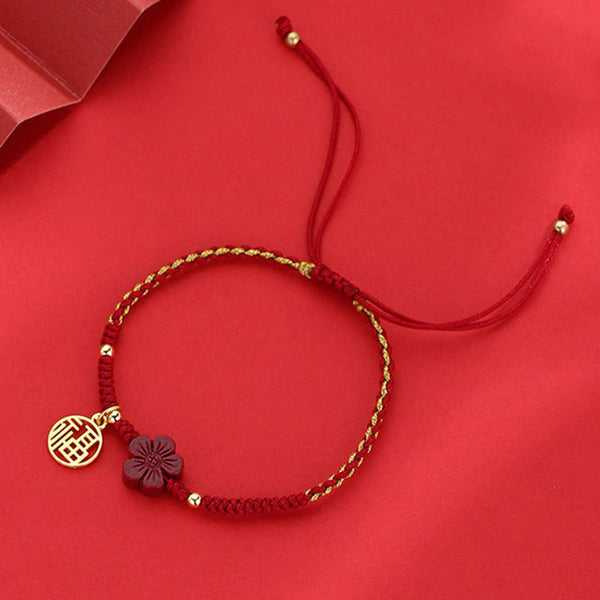 Handmade red braided Chinese bracelet with gold Fu blessing pendant and burgundy flower charm, adjustable lucky knot cord jewelry with red envelope