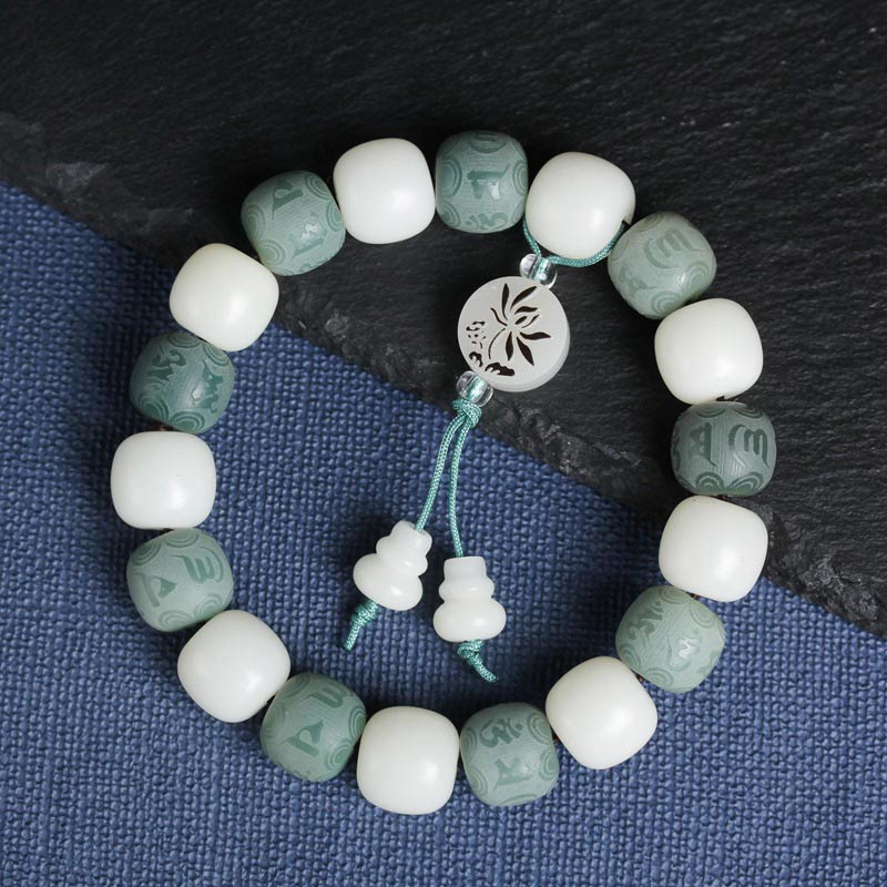 White Bodhi Seed Om Mani Padme Hum Bracelet – Top-down view with lotus medallion, meditation bracelet