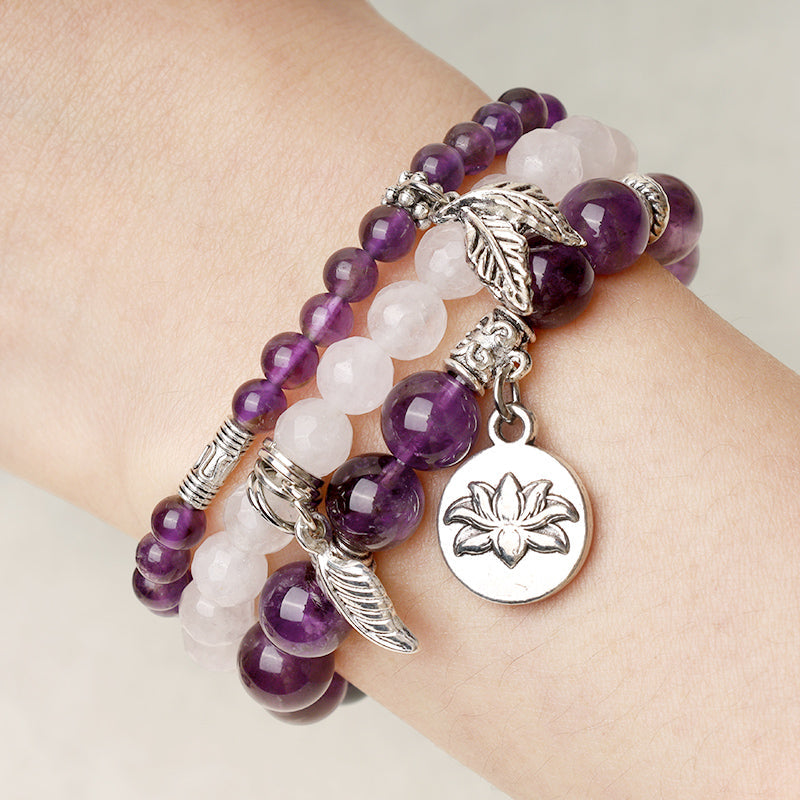 Natural Crystal Bracelet – amethyst and rose quartz layered stack worn on wrist with silver charms, healing jewelry