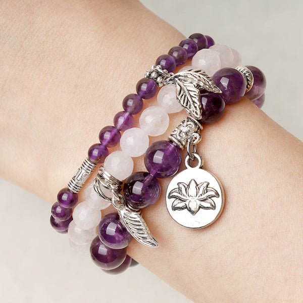 Natural Crystal Bracelet – amethyst and rose quartz layered stack worn on wrist with silver charms, healing jewelry
