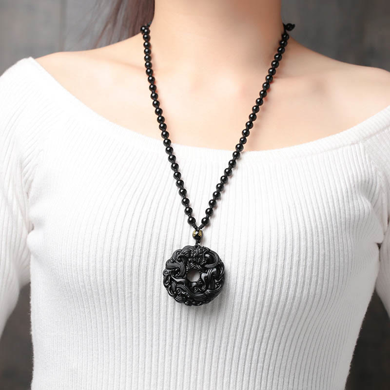 Black Obsidian Pixiu Pendant – Woman wearing black obsidian pendant necklace with white top