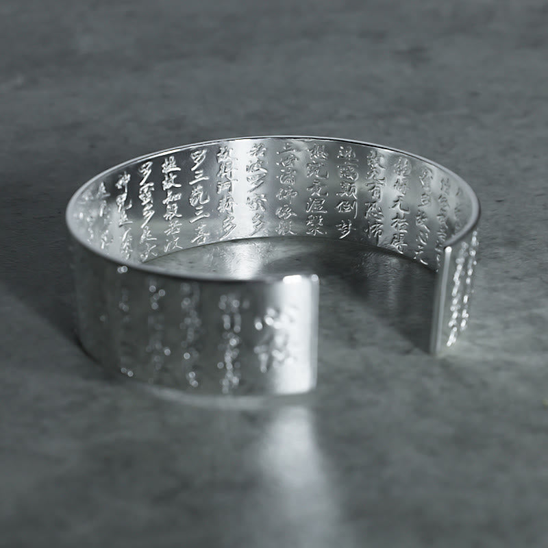 Tibetan Lotus White Copper Luck Bracelet - Silver cuff interior engraved with Buddhist text on dark stone, Inner peace