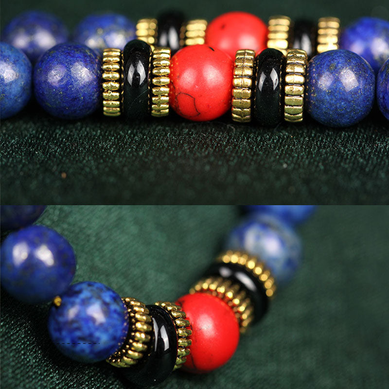 Lapis Lazuli Red Turquoise Tibetan Mala Bracelet dual-angle detail shot, 108 deep blue lapis beads with pyrite inclusions, red coral and black onyx marker beads, gold spacer beads, traditional mala colorway on dark green fabric