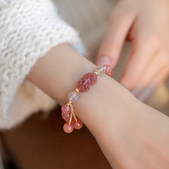 Strawberry Quartz Moonstone Bracelet – model wrist white knit sweater, pink PiXiu detail, love healing