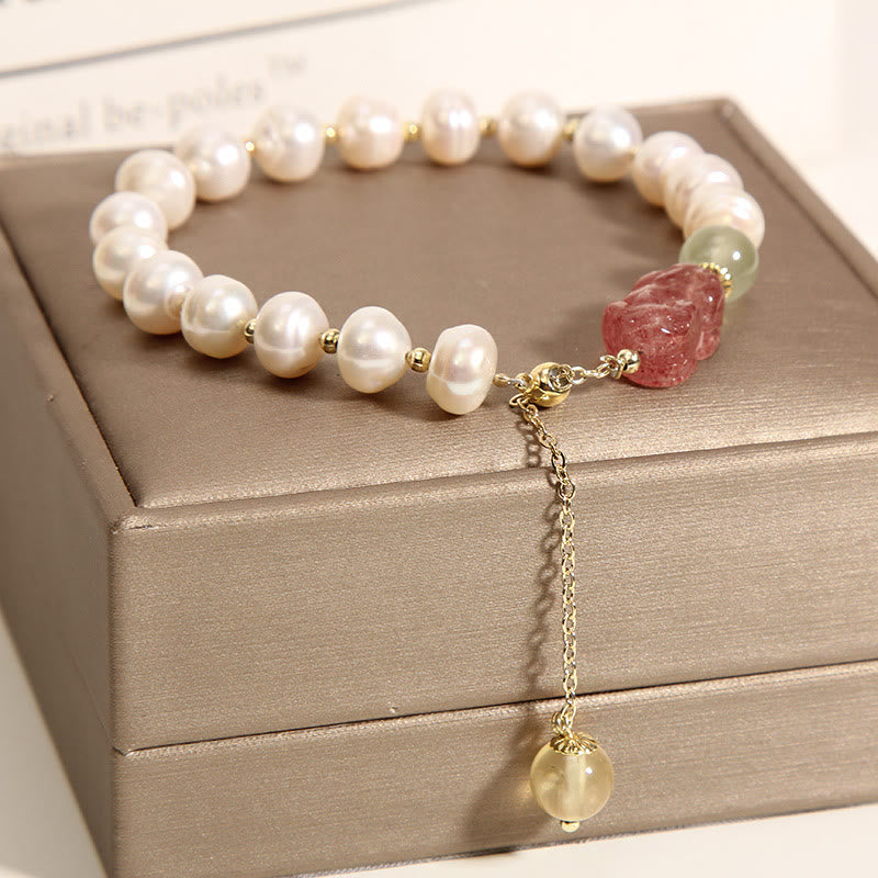Pearl Strawberry Quartz PiXiu Bracelet – Close-up of pearl beads and chain extender on brown box